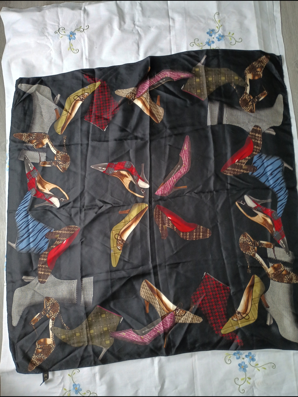 ECHO black silk scarf features an artistic pattern composed of various shoes